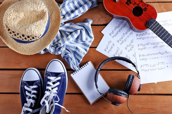 Small guitar, headphones and clothes