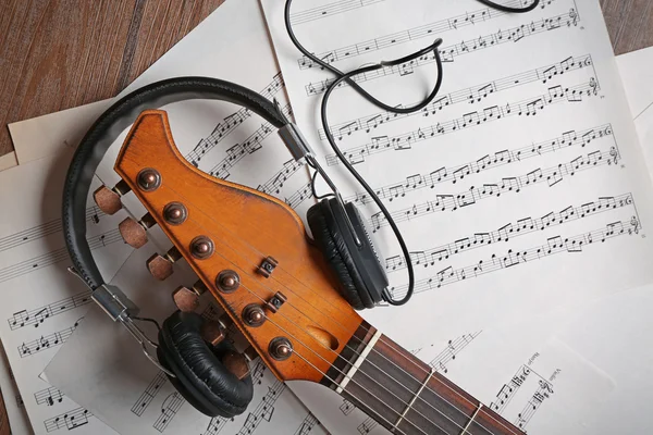 Electric guitar and headphones with music notes