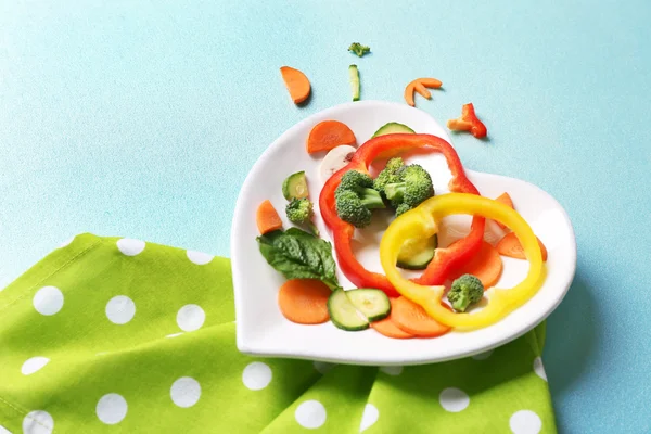 Vegetables on a plate in the form of heart