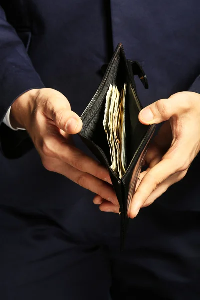 Man showing a purse with banknotes