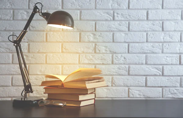 Modern lamp and books on the desk