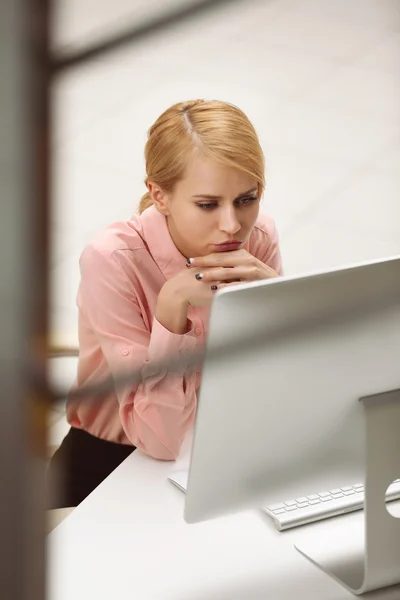 Tired woman at the computer in office