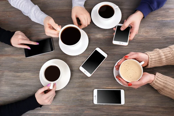 Friends drinking coffee and  smart phones