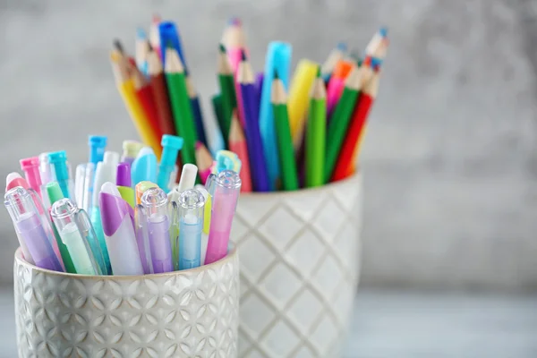 Pens and pencils in cups
