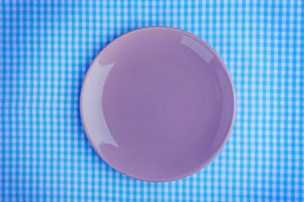 Empty plate on checkered fabric