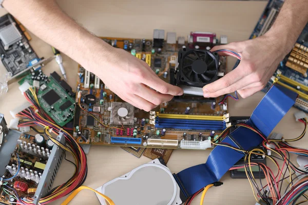 Young man repairing computer hardware