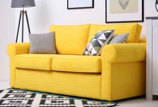 Yellow sofa against wall