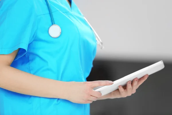 Female doctor holding tablet