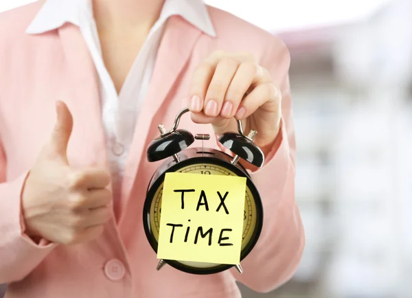 Tax concept. Woman in pink suit