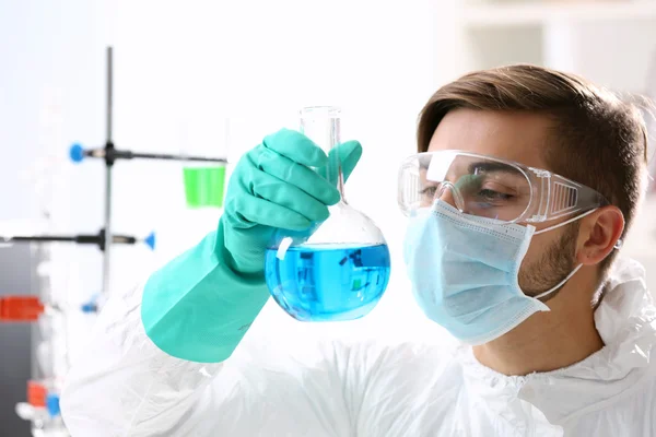 Man in checking test tubes