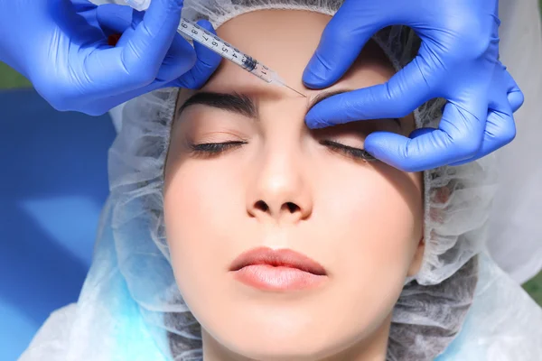 Woman receiving plastic surgery injection