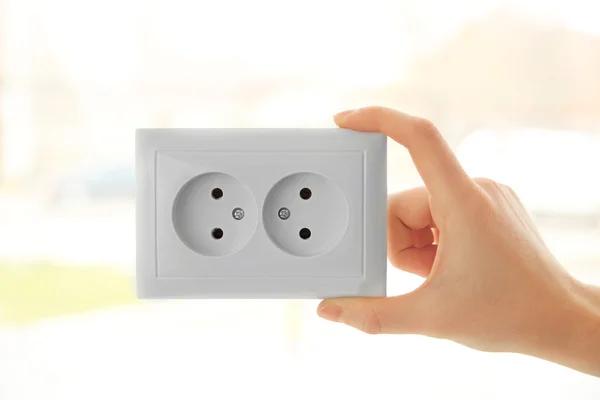 Hand holding power outlet