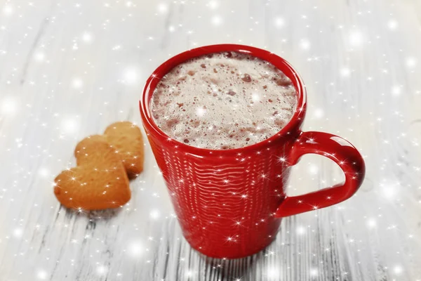 Red cup of hot cacao and cookies