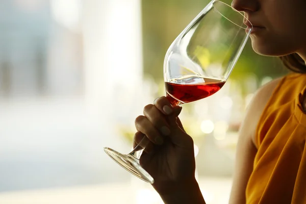 Woman sniffing red wine