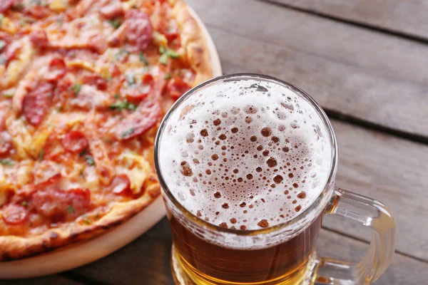 Tasty pizza and glass of beer