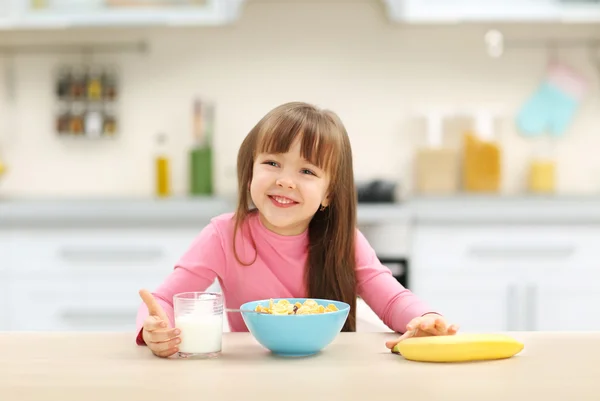 Beautiful little girl having breakfast