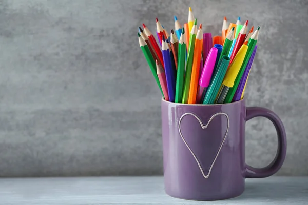 Markers in pencils in ceramic cup