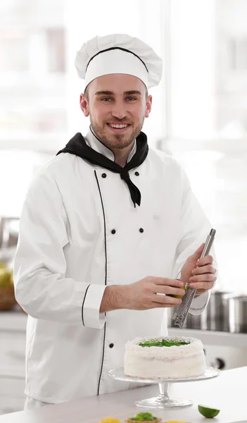 Male chef decorating cake