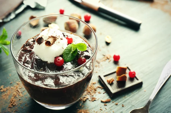 Glass cup of chocolate dessert with cranberries