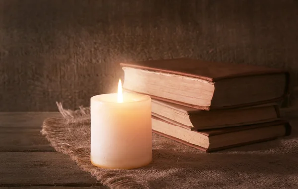 Books and candle on napkin