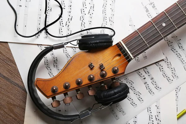 Electric guitar and headphones with music notes