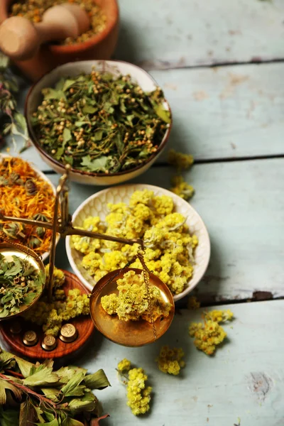 Assortment of dry medicinal herbs in bowls