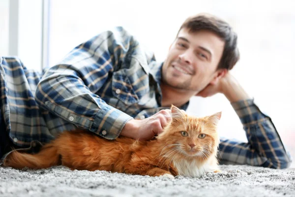 Young man with fluffy cat
