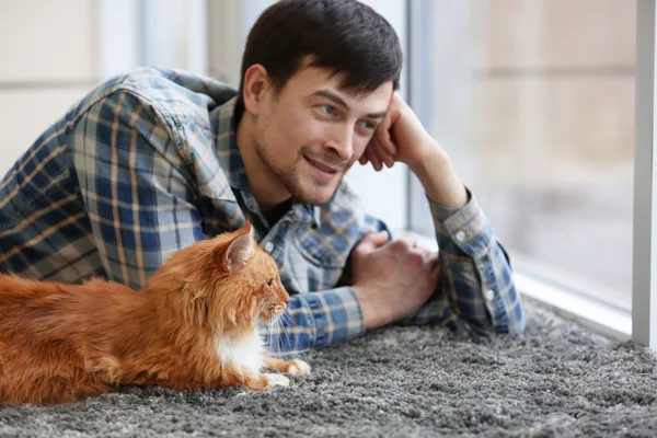 Young man with fluffy cat