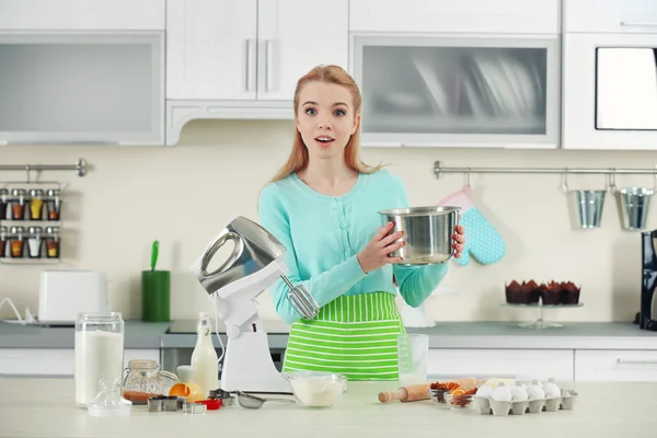 Young woman using a food processor