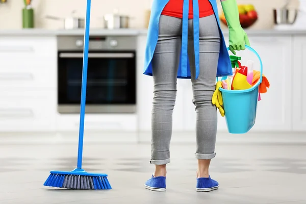 Woman with floor mop and bucket