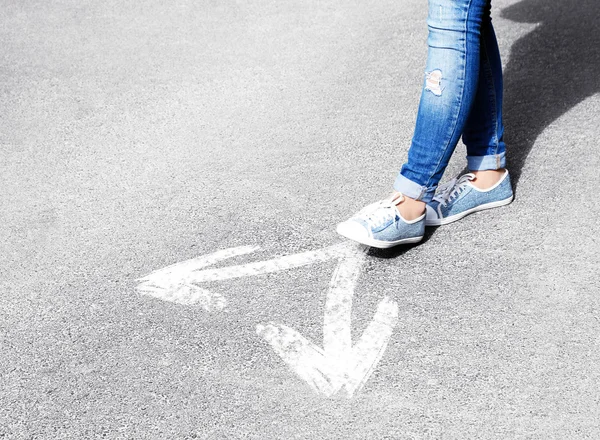 Female feet walking on road