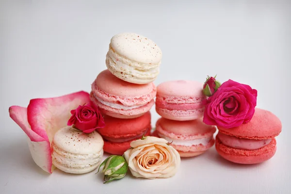 Macaroons with roses on  background