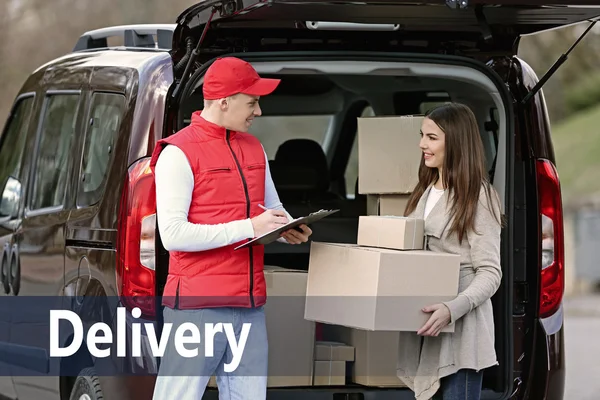 Delivery man and woman receiving a package
