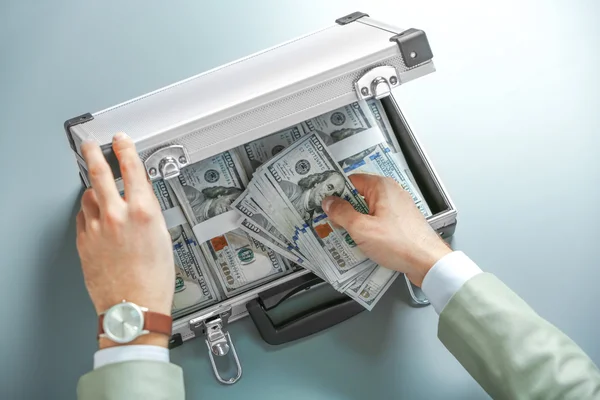 Businessman with case full of money