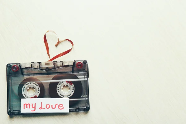 Retro audio cassette with tape in shape of heart