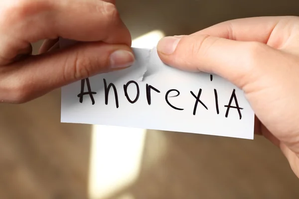 Female hands with word anorexia