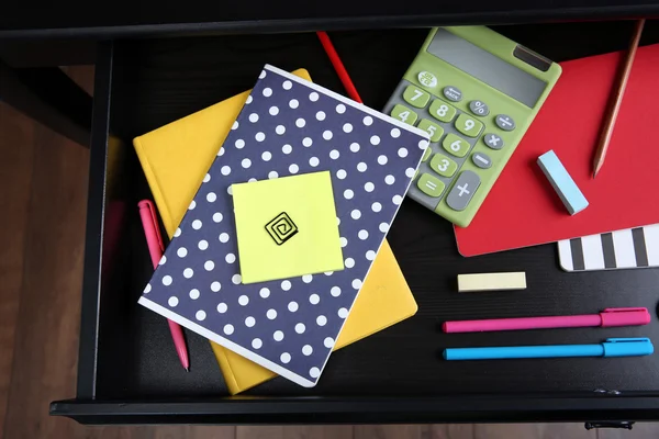 Stationery in open desk drawer