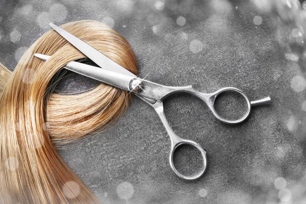 Hairdresser\'s scissors with strand of hair