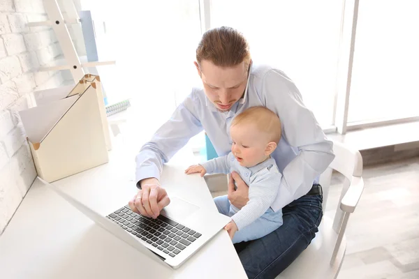 Father with little son working