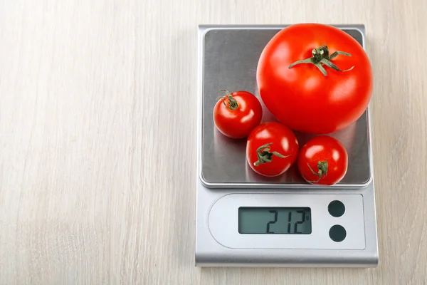 Tomatoes with digital kitchen scales