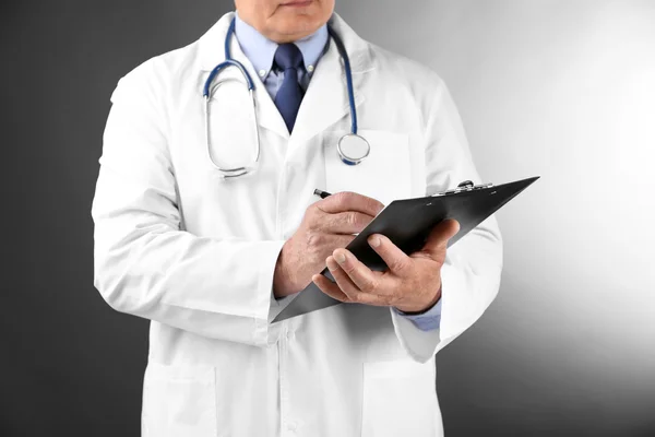 Professional doctor with clipboard