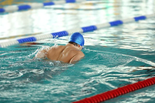 Sporty young man swimming