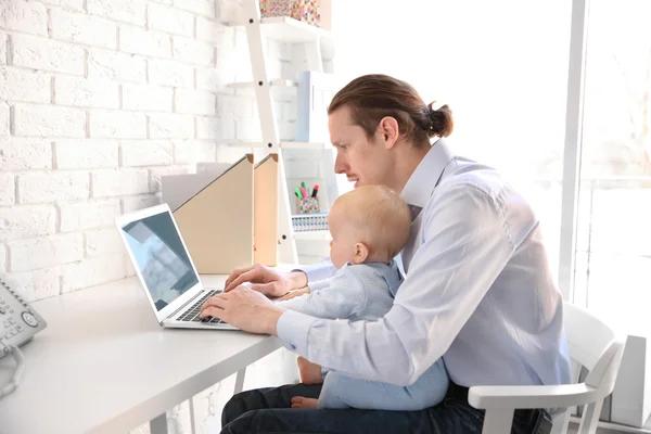 Father with little son working