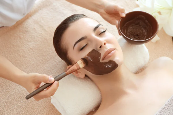 Woman having spa procedure on face