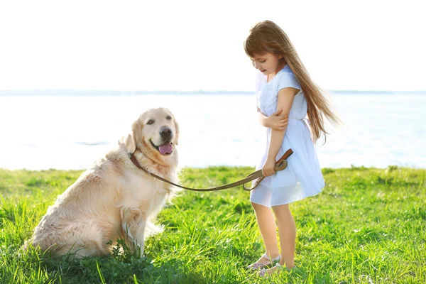 Little girl and big kind dog