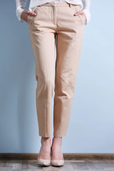 Woman in a white shirt and beige pants