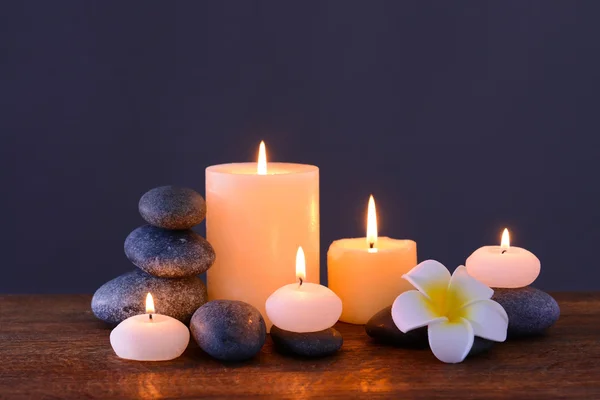 Spa stones with burning candles and flower