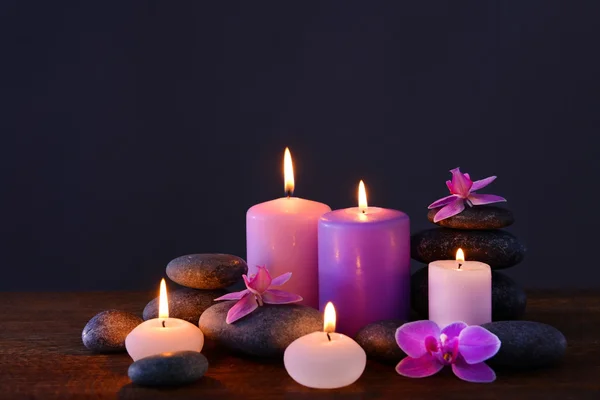 Spa stones with burning candles and flowers