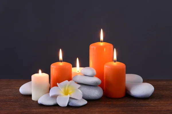 Spa stones with burning candles and flower