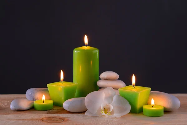 Spa stones with burning candles and flower